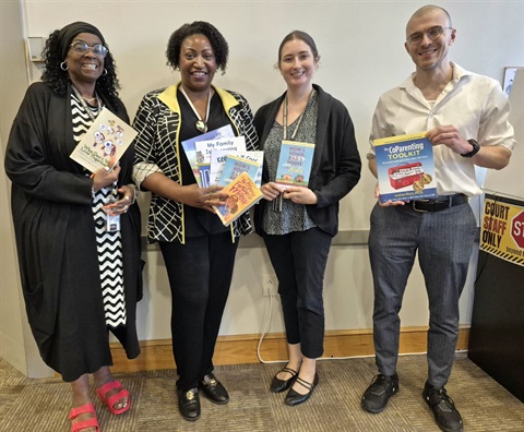 The Dispute Resolution team with books to share with families